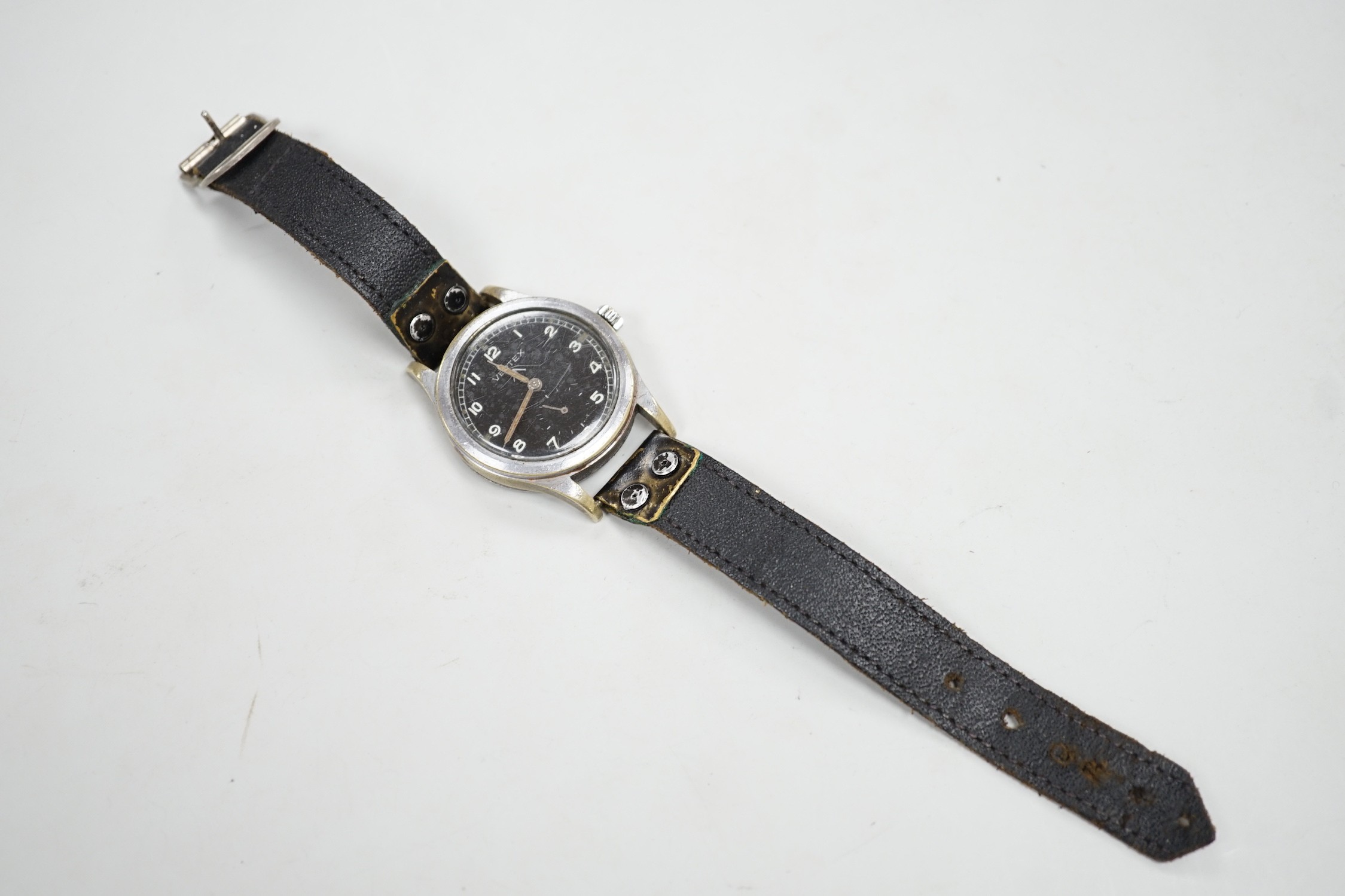 A gentleman's 1940's/1950's military issue steel Vertex manual wind black dial wrist watch (one of the 'dirty dozen' watches), the case back engraved WWW with broad arrow and numbered A 4021 3516937, on a leather strap,